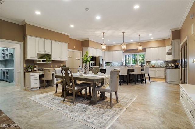 dining space with crown molding