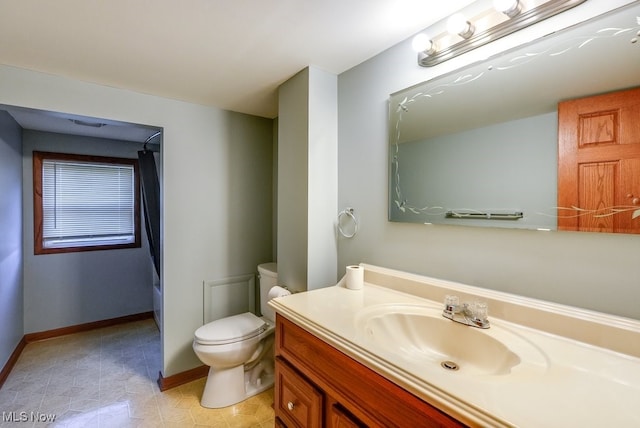 bathroom featuring vanity, a shower with curtain, and toilet