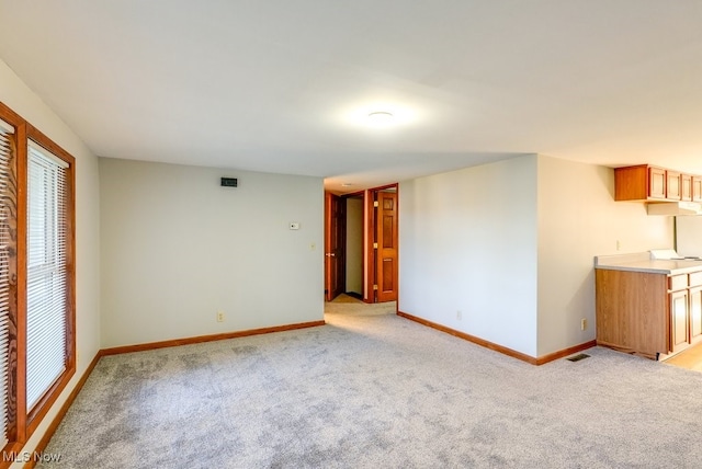 unfurnished room featuring light colored carpet