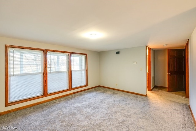 empty room featuring light carpet