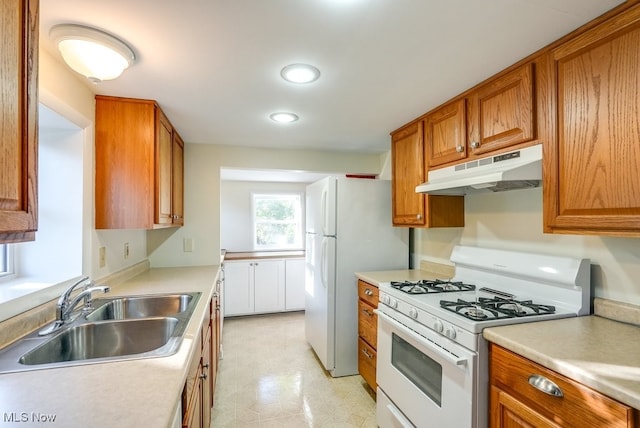 kitchen featuring sink and white appliances