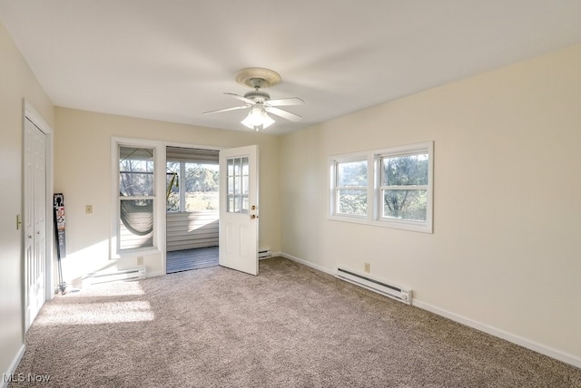 carpeted spare room with ceiling fan and baseboard heating