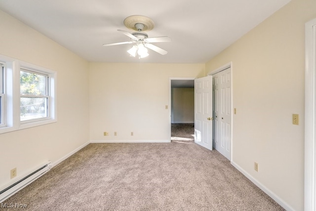 carpeted empty room with a baseboard radiator and ceiling fan