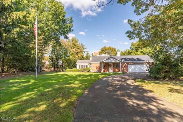 ranch-style house with a front yard and a garage