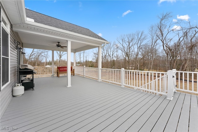 wooden terrace featuring area for grilling and ceiling fan