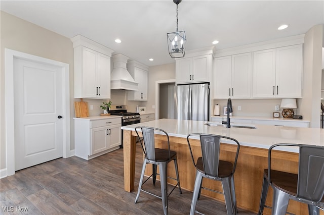 kitchen featuring custom range hood, appliances with stainless steel finishes, dark hardwood / wood-style floors, and white cabinets