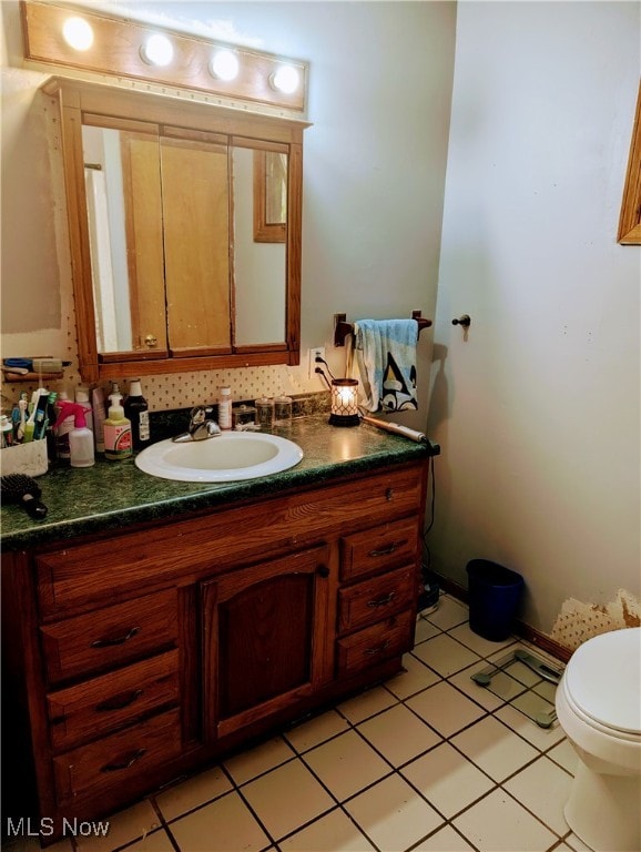 bathroom with vanity, toilet, and tile patterned floors