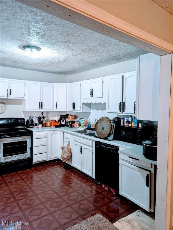 kitchen with black appliances, sink, a textured ceiling, dark parquet flooring, and white cabinets