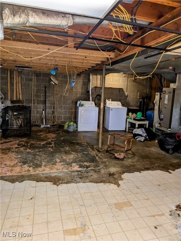 basement featuring independent washer and dryer and heating unit