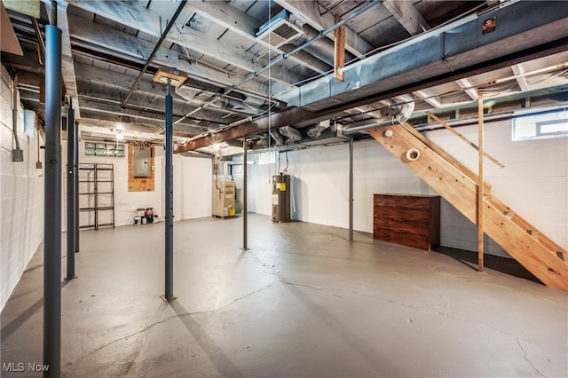 basement featuring electric water heater and electric panel