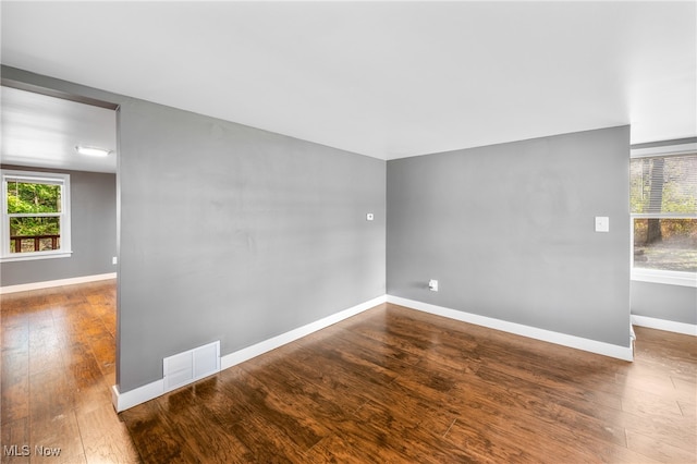 spare room featuring dark hardwood / wood-style floors