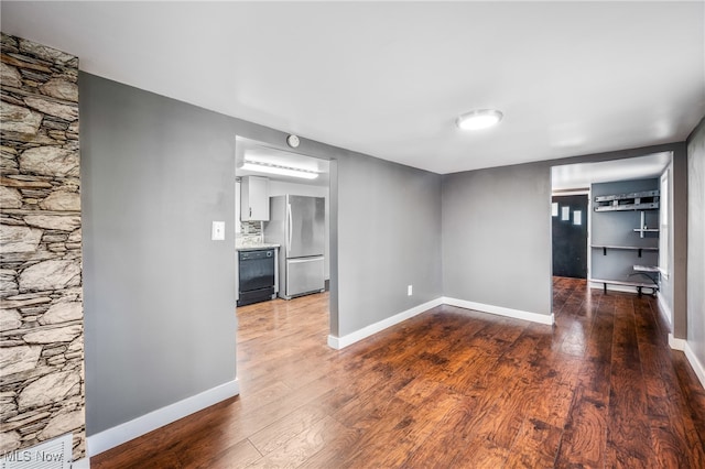 spare room featuring dark hardwood / wood-style flooring