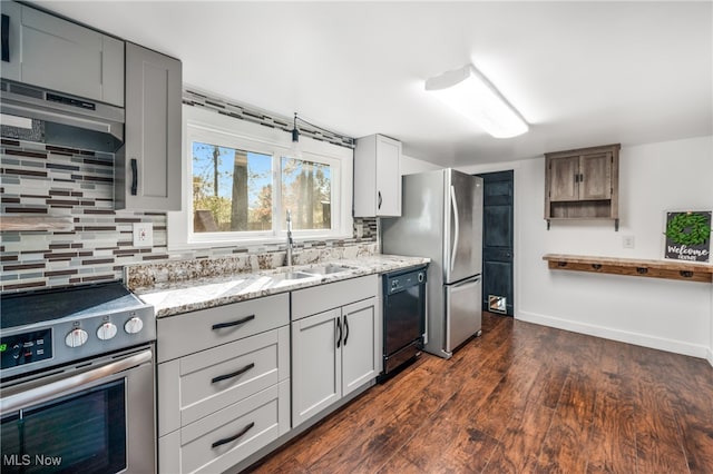 kitchen featuring extractor fan, stainless steel appliances, sink, dark hardwood / wood-style flooring, and tasteful backsplash