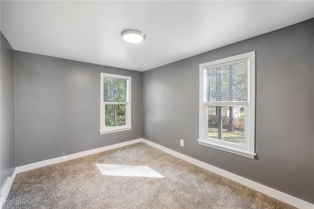 carpeted empty room with plenty of natural light