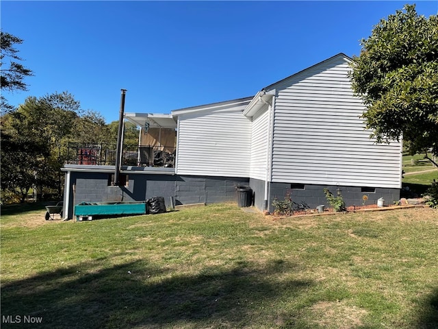 view of side of home featuring a yard