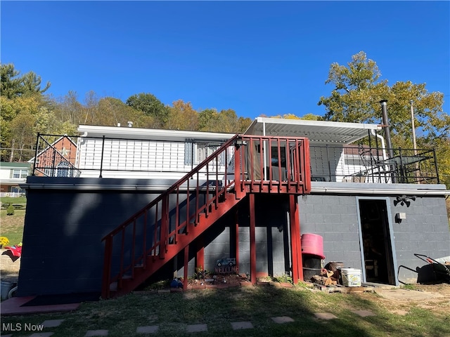 back of house with a wooden deck