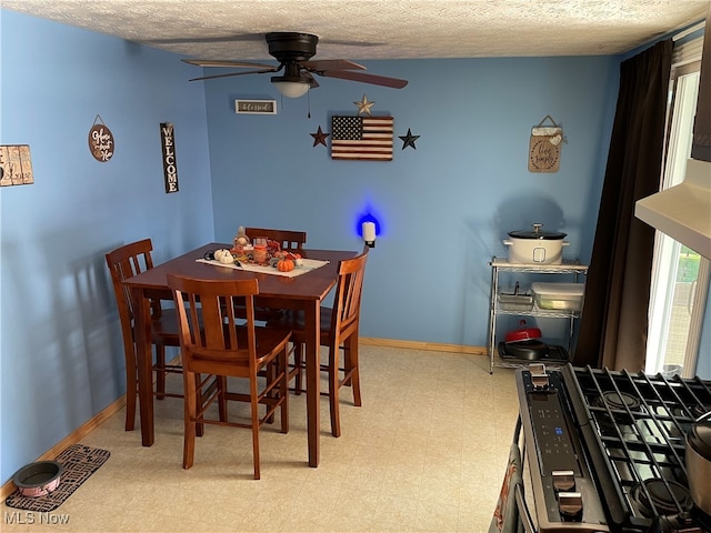 dining area with a textured ceiling and ceiling fan