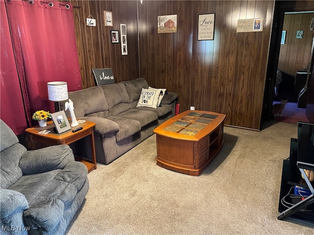 living room with light colored carpet and wooden walls