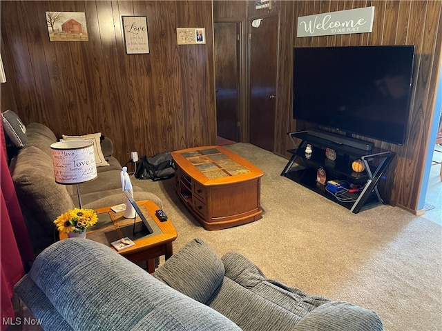 living room featuring wood walls and carpet