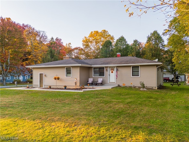 rear view of property with a lawn