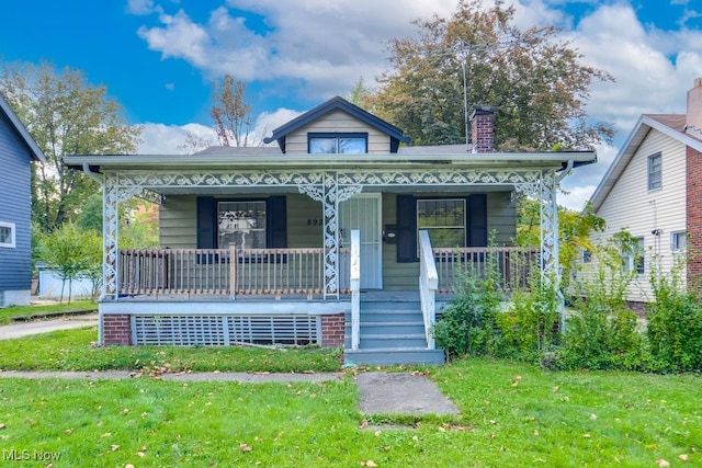 bungalow-style house with a front lawn and a porch