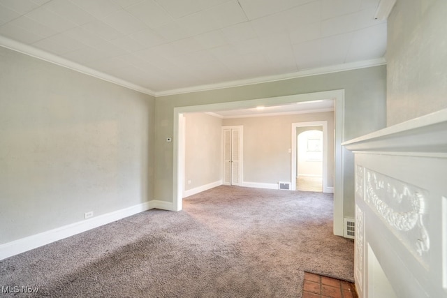 spare room featuring carpet and crown molding