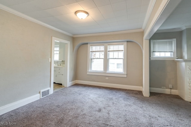 unfurnished bedroom with ornamental molding, light carpet, and ensuite bath