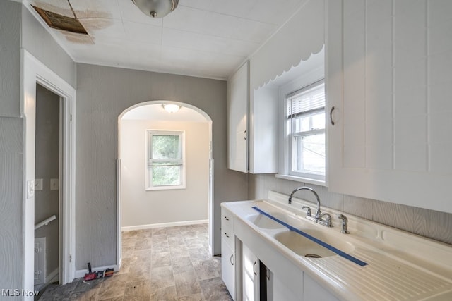 kitchen featuring sink and white cabinets