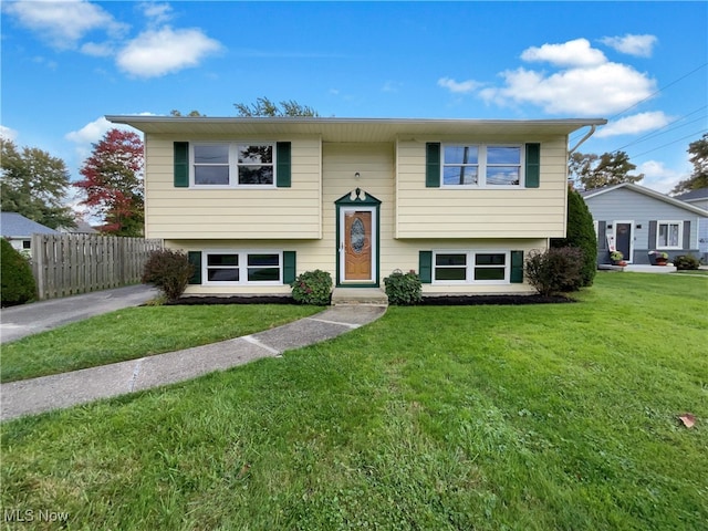 bi-level home with a front lawn