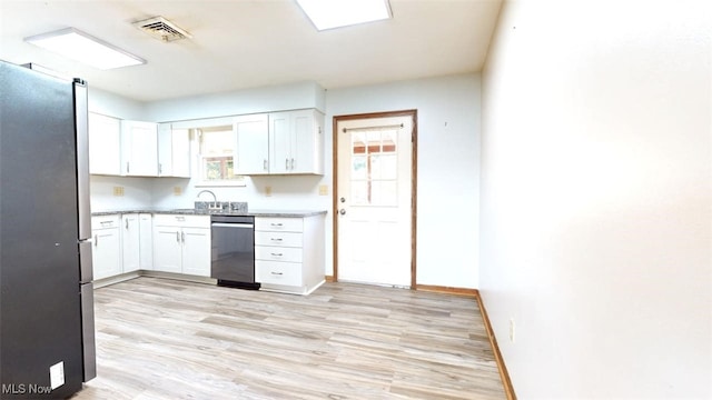 kitchen with stainless steel appliances, light wood-type flooring, and white cabinets