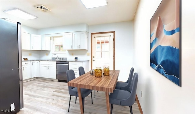 kitchen featuring light hardwood / wood-style floors, white cabinets, and appliances with stainless steel finishes