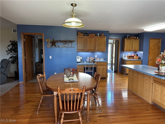 dining area with light hardwood / wood-style flooring and beverage cooler