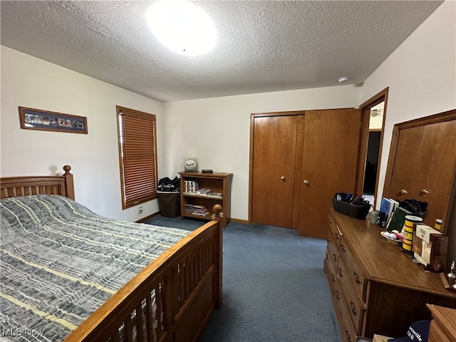 bedroom with a closet, a textured ceiling, and dark colored carpet