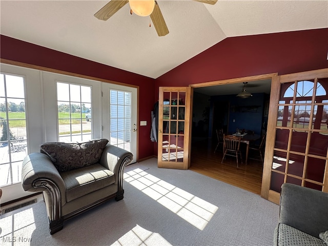 living room with french doors, ceiling fan, wood-type flooring, and vaulted ceiling