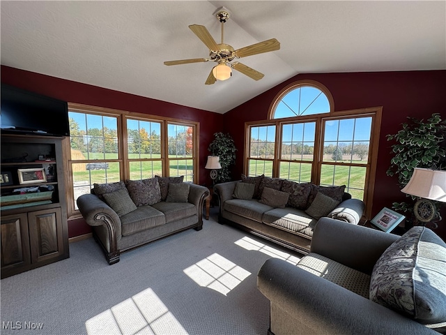 living room with ceiling fan, light carpet, and lofted ceiling