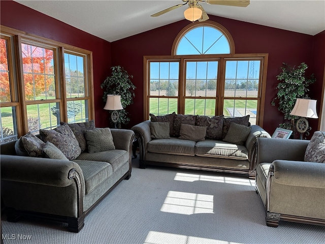 living room with lofted ceiling, carpet, and ceiling fan