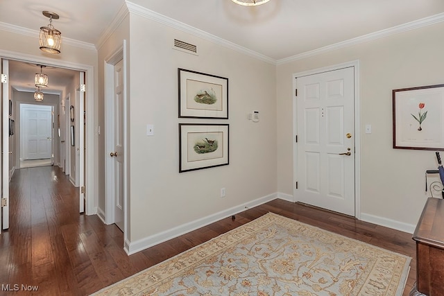 foyer with crown molding and dark hardwood / wood-style floors