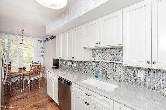 kitchen featuring white cabinetry, dishwasher, dark hardwood / wood-style floors, decorative light fixtures, and sink