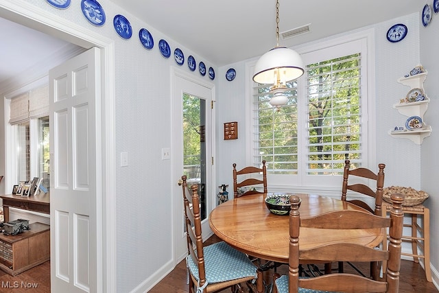 dining area featuring a wealth of natural light and dark hardwood / wood-style flooring