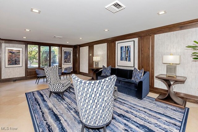 living room with crown molding and light tile patterned floors