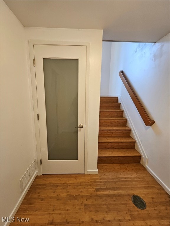 stairway featuring hardwood / wood-style floors