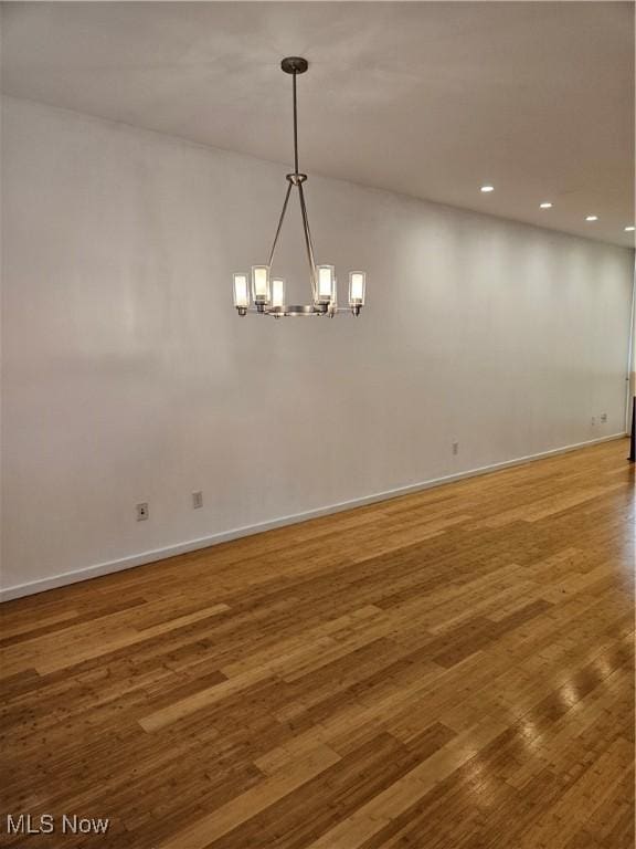 11803 Euclid Ave, Cleveland, OH 44106 - unfurnished room with a chandelier, wood finished floors, baseboards, and recessed lighting