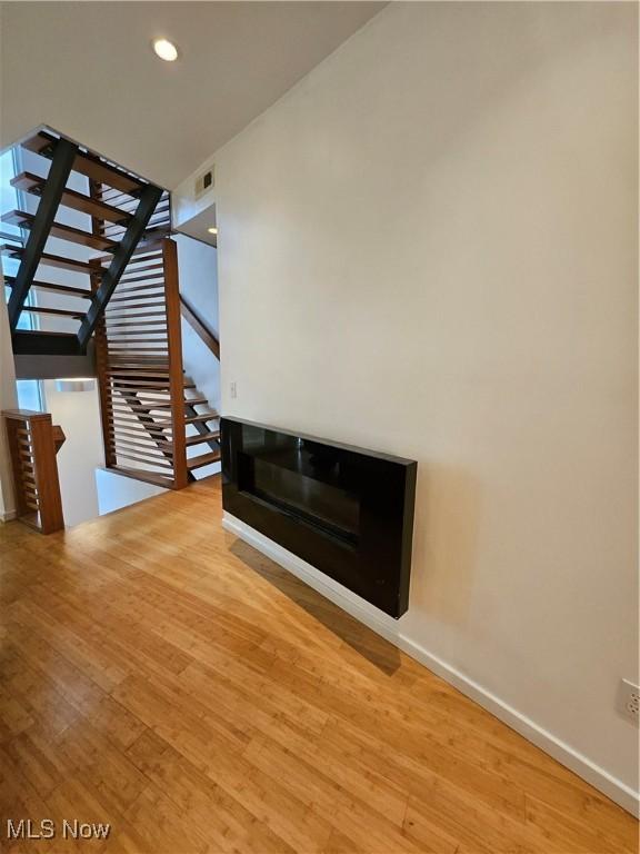 11803 Euclid Ave, Cleveland, OH 44106 - unfurnished living room with wood finished floors, baseboards, and recessed lighting