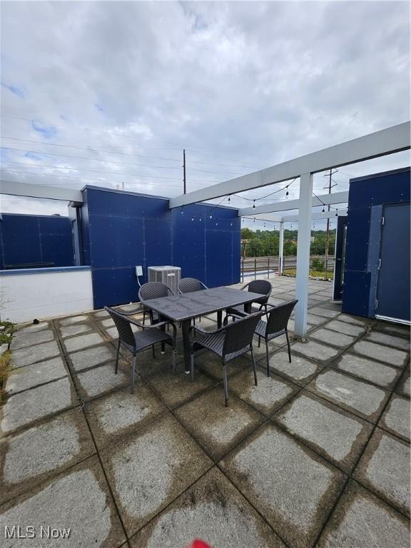11803 Euclid Ave, Cleveland, OH 44106 - view of patio with outdoor dining area and central AC