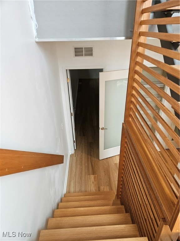 stairway featuring hardwood / wood-style flooring