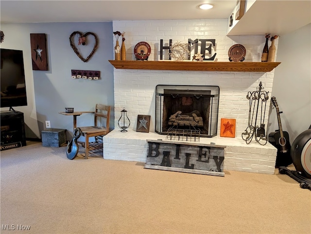 living room featuring carpet and a brick fireplace