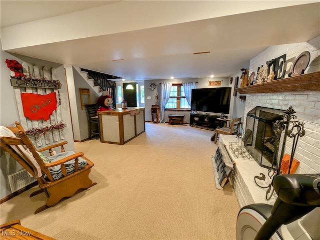 living room featuring a brick fireplace and light colored carpet