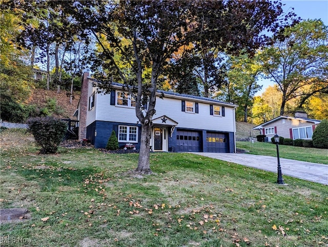 view of front of house with a garage and a front lawn