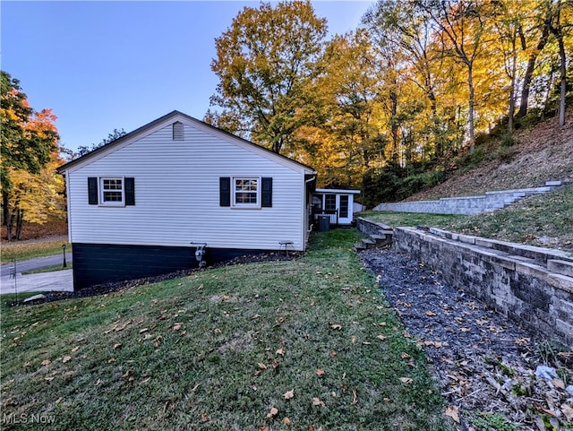 view of home's exterior featuring a lawn and central AC unit