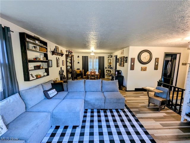 living room featuring a textured ceiling and hardwood / wood-style flooring